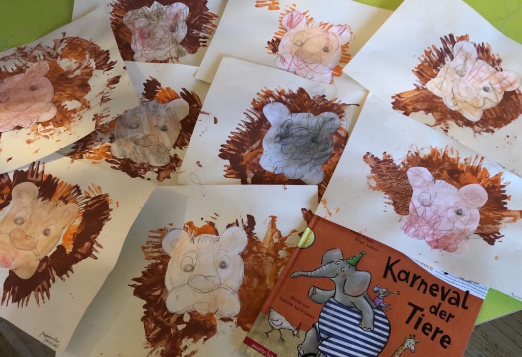 Von Kita-Kindern gemalte Löwenbilder zum Thema Karneval der Tiere.
